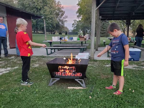 Two children enjoying a fire