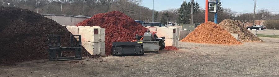 Three colors of mulch are present in a large lot