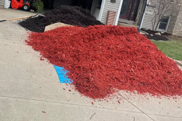 Red mulch covers a wide driveway