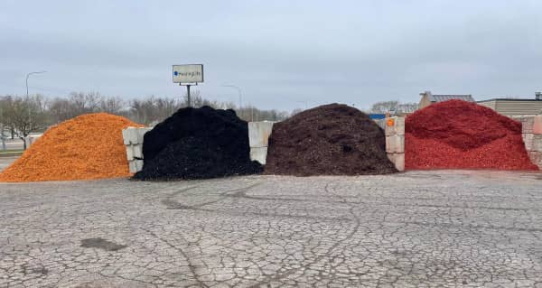 Piles of black, brown, red and gold-colored mulch