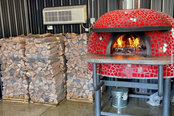 Stack of cooking wood with a cooking wood oven in Minneapolis