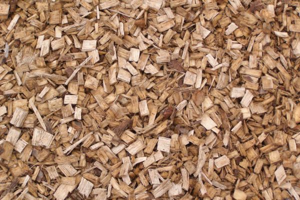 A close-up image of natural brown bark mulch