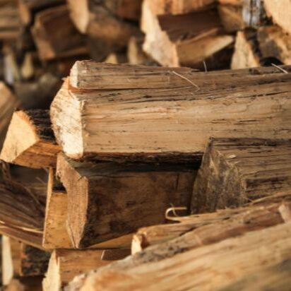 Close-up image of stacked and cut firewood logs