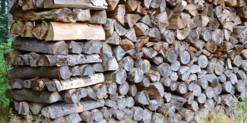 A face cord of wood sits next to a full cord of wood